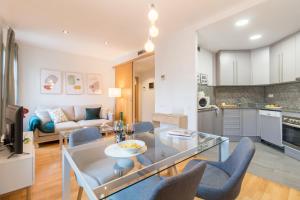 a kitchen and living room with a glass table and chairs at Sibs Bcn- Balmes- Romantic CityCentre Beautiful in Barcelona