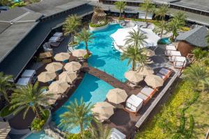 an aerial view of a resort swimming pool with umbrellas at Patong Bay Hill Resort in Patong Beach