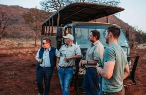 a group of men standing in front of a truck at Kilima Private Game Reserve & Spa in Gravelotte