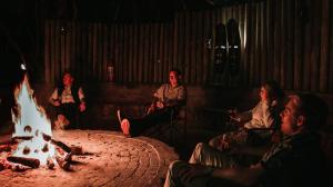 a group of people sitting around a fire pit at Kilima Private Game Reserve & Spa in Gravelotte