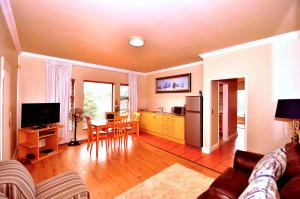 a living room with a kitchen and a dining room at Casa Mia Guesthouse in Table View