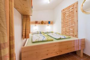 a bedroom with a wooden bed in a room at Almliesl STVE-510 in Sankt Veit im Pongau