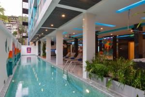 a swimming pool in the middle of a building at T2 Ao Nang Krabi in Ao Nang Beach