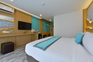 a bedroom with a large bed and a flat screen tv at T2 Ao Nang Krabi in Ao Nang Beach