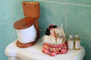 a doll sitting on top of a toilet in a bathroom at Cancun Guest House 1 in Cancún