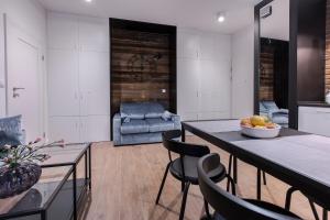 a kitchen and living room with a table and chairs at City Break Gdańsk Rajska 8 Apartamenty in Gdańsk
