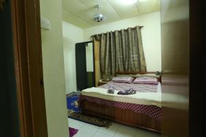 Säng eller sängar i ett rum på Singgahan Keluarga Jitu
