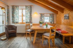a dining room with a wooden table and chairs at Pension Juliana in Lech am Arlberg