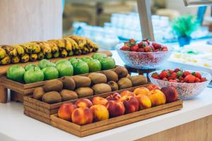 a display of fruits and vegetables on a counter at Iberostar Selection Marbella Coral Beach in Marbella