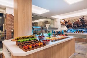 a buffet line with fruits and vegetables on display at Iberostar Selection Marbella Coral Beach in Marbella
