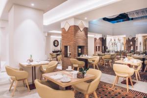a restaurant with tables and chairs in a room at Iberostar Selection Marbella Coral Beach in Marbella