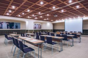 a conference room with tables and chairs and a screen at Iberostar Selection Marbella Coral Beach in Marbella