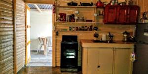 a kitchen with a stove and a sink in it at El Conde de Villa Rosa in Salado