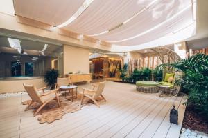 a lobby with chairs and tables in a building at Iberostar Selection Marbella Coral Beach in Marbella