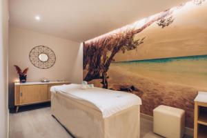 a bedroom with a painting of a tree on the wall at Iberostar Selection Marbella Coral Beach in Marbella