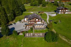 an aerial view of a large house in a field at Baita Fraina in Cortina dʼAmpezzo