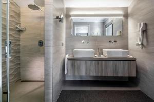 a bathroom with two sinks and a shower at Suite Apartment Exclusive in Bellaria-Igea Marina +164 photos