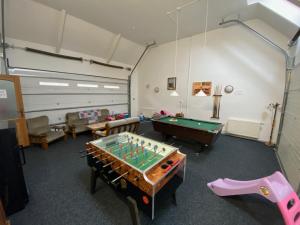 a room with a pool table and ping pong ball at Vila Veronika in Lednice