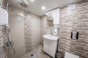 a bathroom with a sink and a toilet and a shower at Sofia Parter Life Apartment in Sofia +17 photos