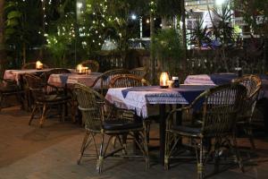a group of tables and chairs with lights on them at Sea View Resort in Patnem