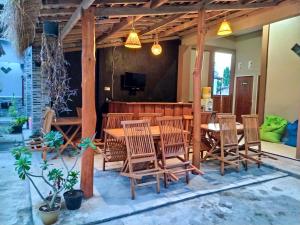 a dining room with a table and chairs at Asta Homestay in Karimunjawa