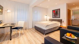 ein Hotelzimmer mit einem Bett und einem Wohnzimmer in der Unterkunft Art of Comfort Haus Ingeborg in Köln