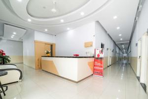 a lobby of a hospital with a reception counter at RedDoorz Plus near Thamrin Plaza Medan in Medan