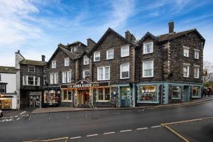 a large brick building on the side of a street at The Ambleside Inn - The Inn Collection Group in Ambleside