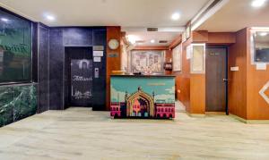 a lobby with a building painted on the wall at Hotel Amanda in Lucknow