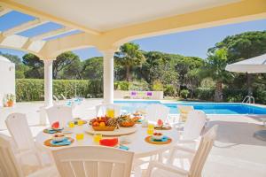 - une table avec des fruits sur la terrasse avec une piscine dans l'établissement Villa Tulum by Algarve Vacation, à Almancil