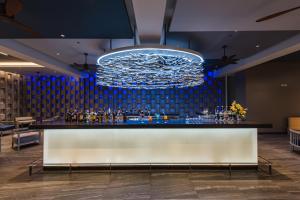 a bar in a restaurant with a blue wall at Oceanfront Beach Resort - SHA Extra Plus in Patong Beach