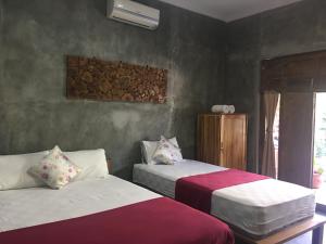 Ein Bett oder Betten in einem Zimmer der Unterkunft Watukarung Ristu Homestay