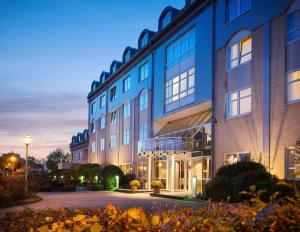 a large blue building with a lot of windows at Sachsenpark-Hotel in Leipzig