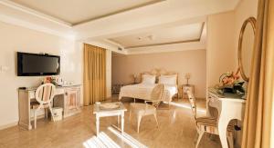 a hotel room with a bed and a television at Hotel Azimut in Sveti Stefan