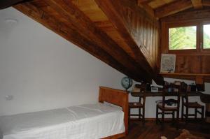En eller flere senge i et værelse på Case Gran Paradiso di Charme Villaggio La Barmaz