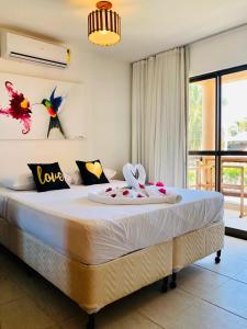 a bedroom with a large bed with birds on the wall at Cumbuco Dream Village Luxury Condo in Cumbuco