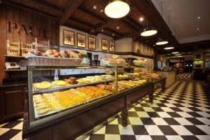 a bakery with a display case filled with different types of pastries at Sheikh Apartment in Baku in Baku
