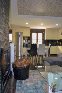 a kitchen and living room with a glass table at Casinha do Eido Novo - Alojamento Local in Valença