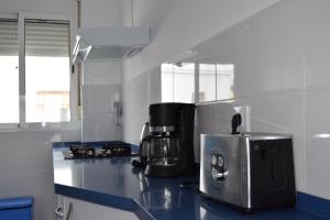 a kitchen with a counter with a coffee maker on it at Enjoy Sevilla in Seville