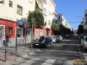 a street with cars parked on the side of the road at Enjoy Sevilla in Seville