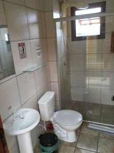 a bathroom with a toilet and a sink and a shower at Pousada Agronomia in Porto Alegre