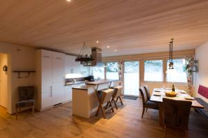 a kitchen and dining room with a table and chairs at Appartement Seebachsee in Warth am Arlberg