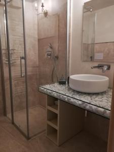 a bathroom with a sink and a shower at Casa Orrù in Nuoro