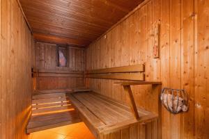 an empty wooden sauna with a bench in it at Apartment Butorowy Residence by Renters Prestige in Kościelisko