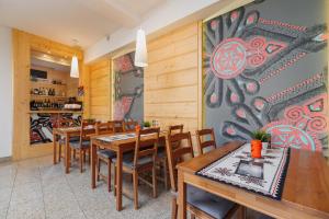 a dining room with wooden tables and chairs at Apartment Butorowy Residence by Renters Prestige in Kościelisko
