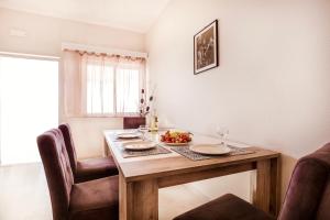 a dining room table with a bowl of fruit on it at Nissaki Suite Poseidon by Sealand Villas in Nisakion