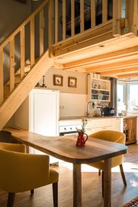 a kitchen with a wooden table and chairs in a room at Jungholz Chalet 65 in Jungholz