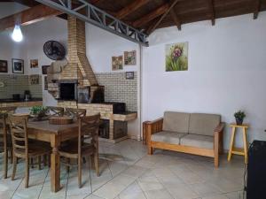 a living room with a table and a couch at iUP HOUSE Hostel in Blumenau