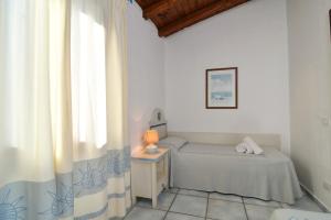 Postel nebo postele na pokoji v ubytování Li Suari Club Village