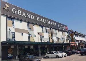 a large building with cars parked in a parking lot at Grand Hallmark Hotel - Johor Bahru in Johor Bahru